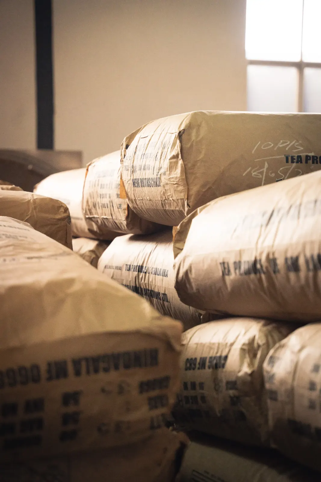 Graded Ceylon tea sacks in storage, marked Tea Produce of Sri Lanka